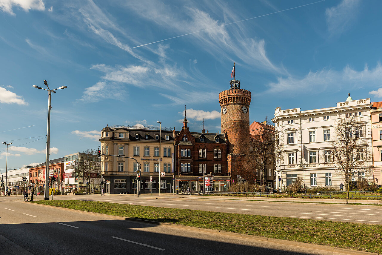Straßenansicht von Cottbus umgeben von zahlreichen Altbauten, bei klarem Tageslicht.
