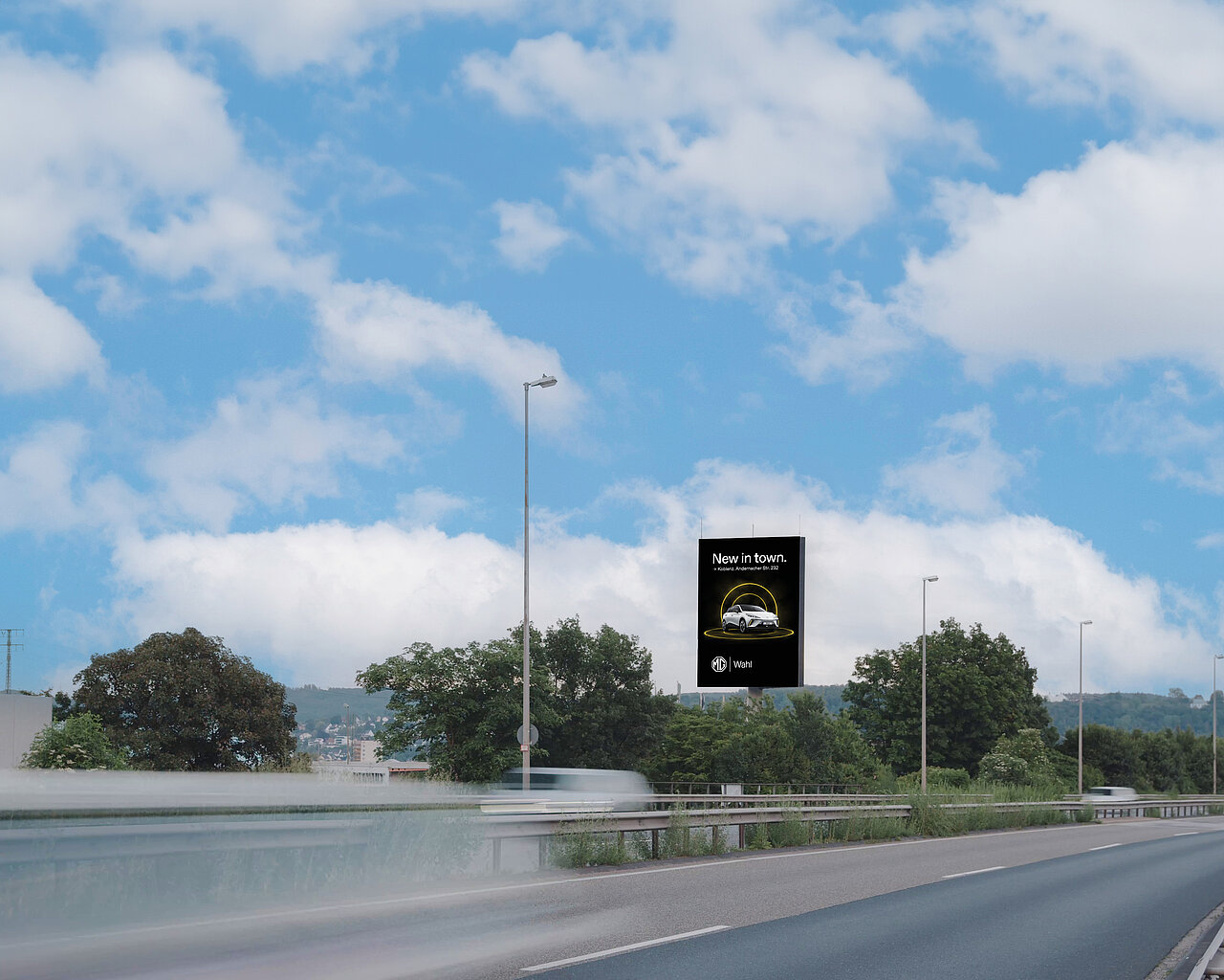 Digitaler Tower an der B9 in Koblenz bei Tageslicht und hohem Verkehrsaufkommen mit Werbung von MG Motor. 